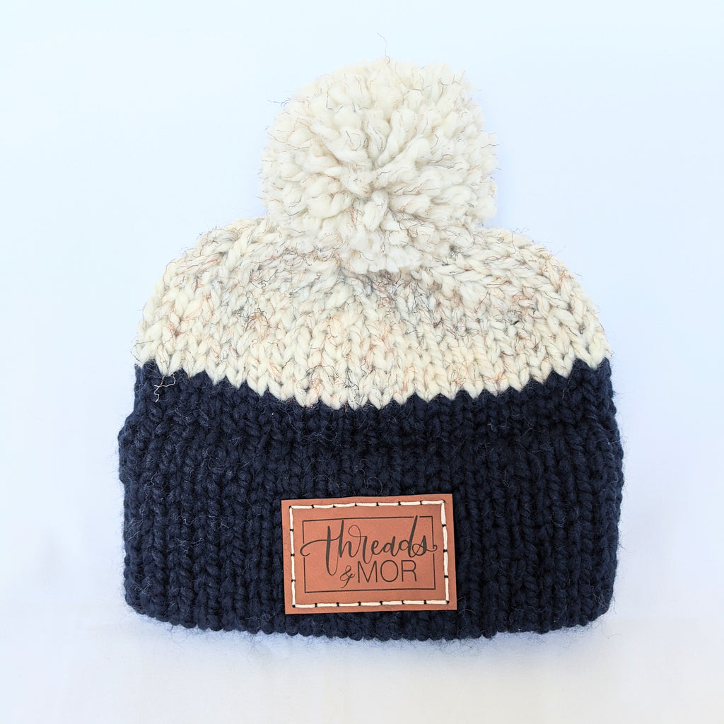 Navy and wheat double brim knit hat with yarn pompom