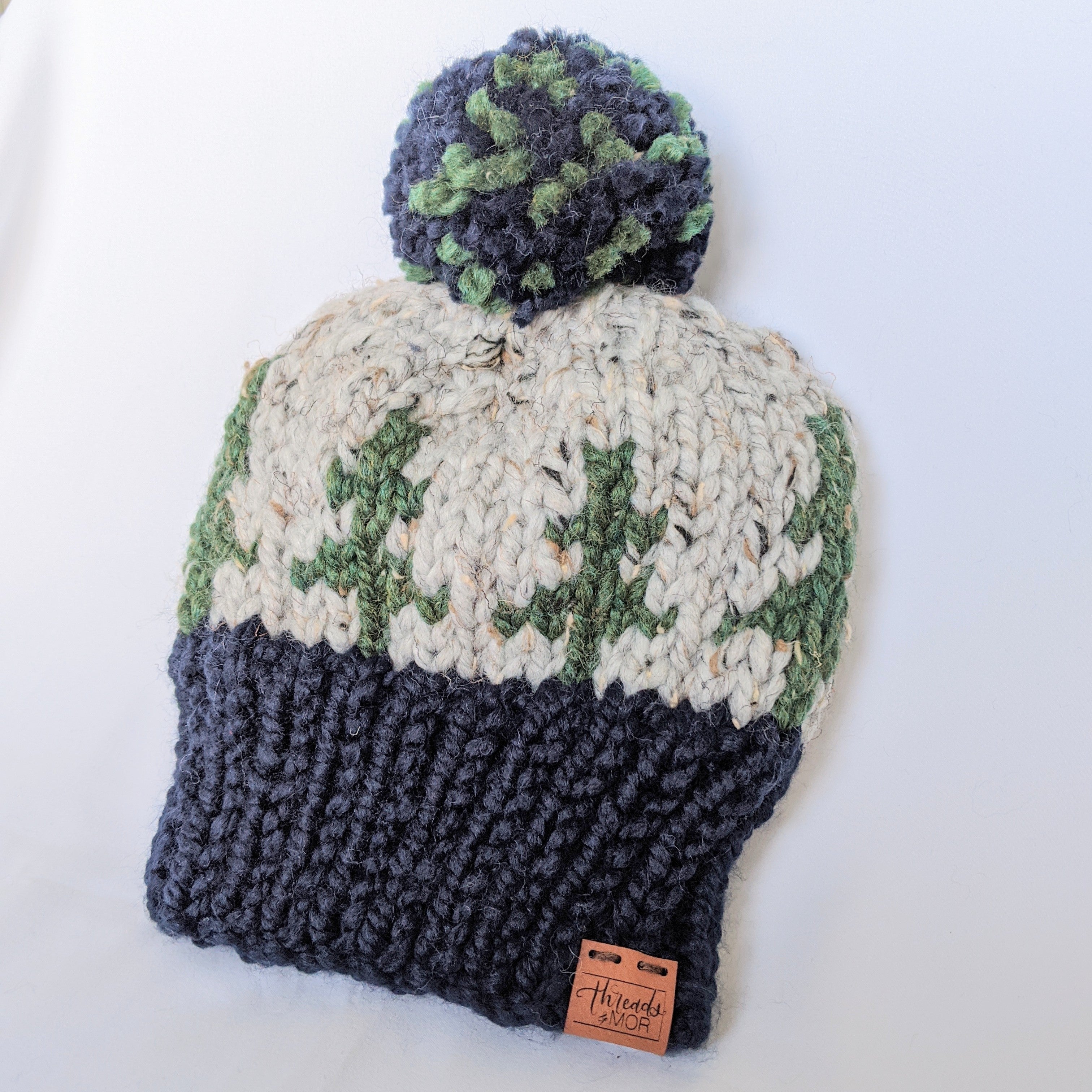 Evergreen knit beanie hat with yarn pompom