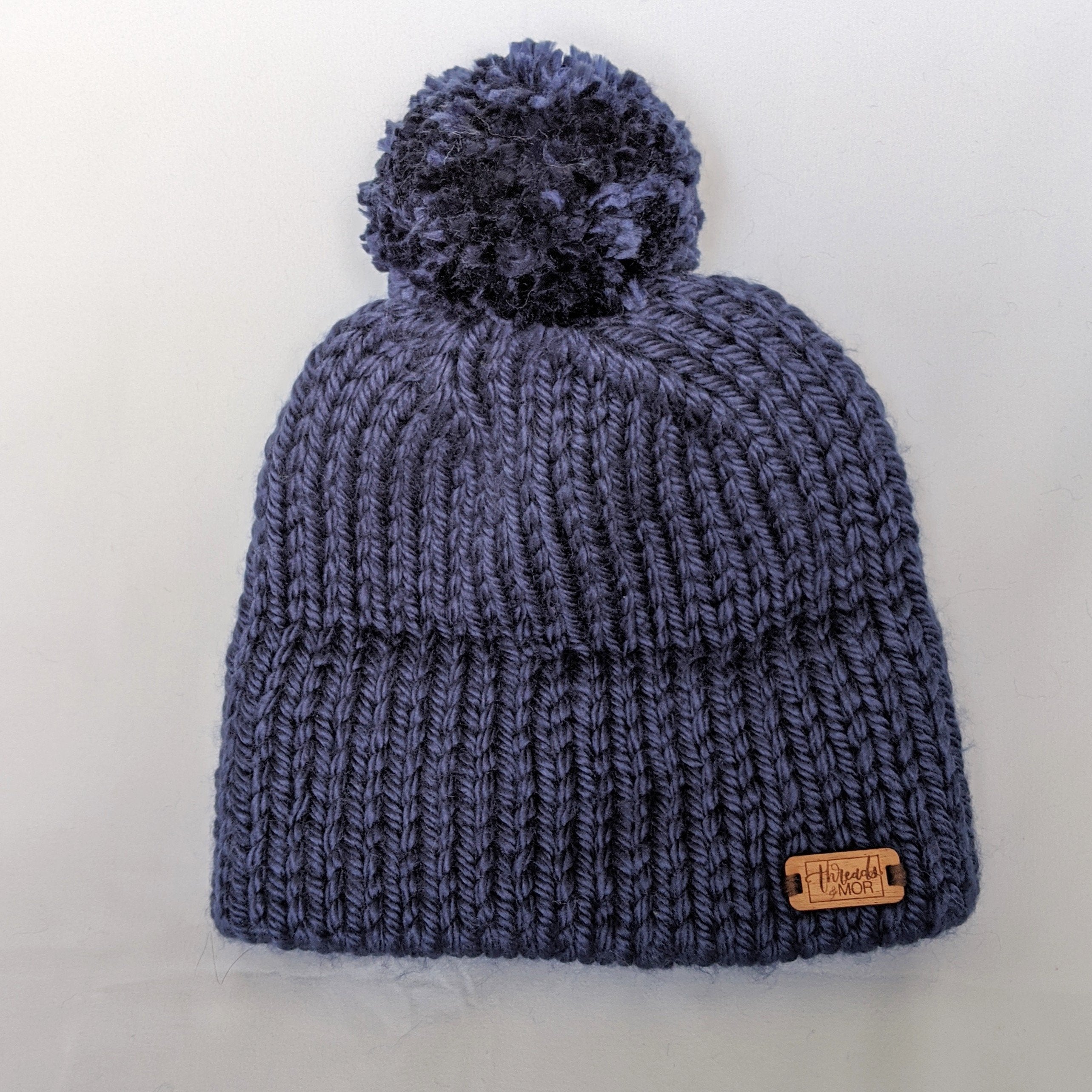 Navy double brim knit hat with yarn pompom