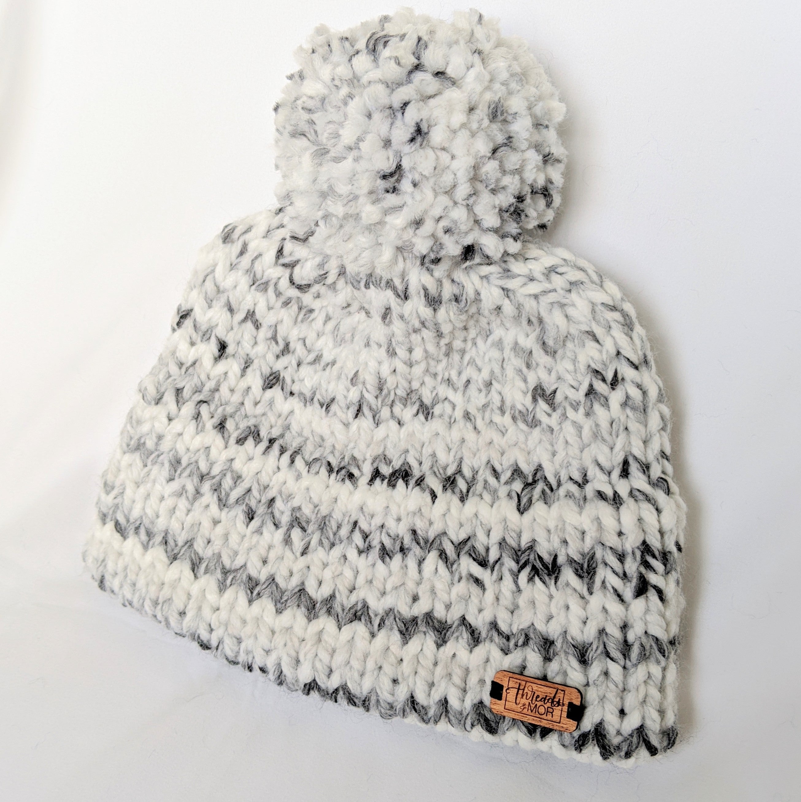 White and gray stripped double brim knit hat with yarn pompom