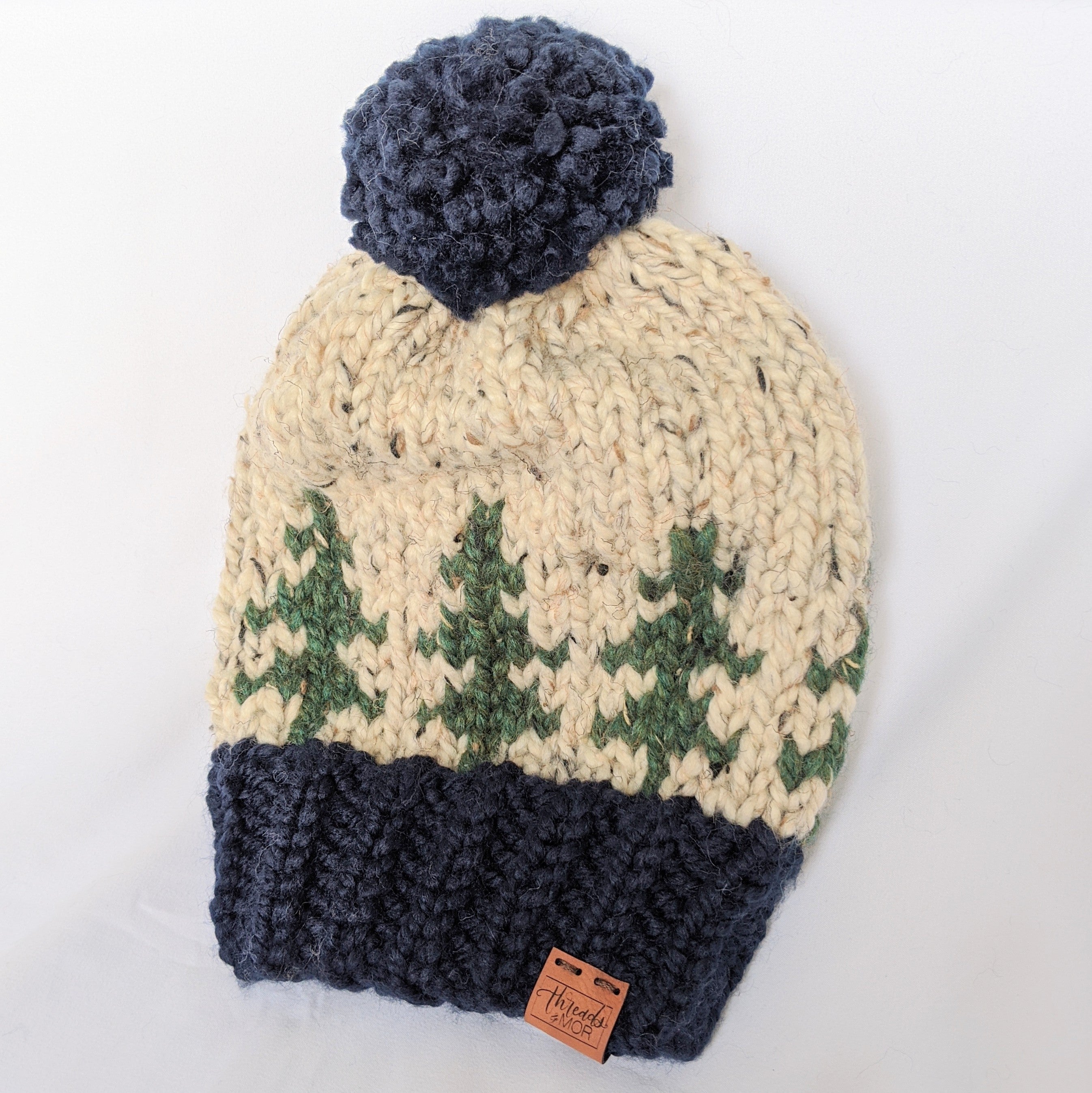 Evergreen slouchy knit hat with yarn pompom